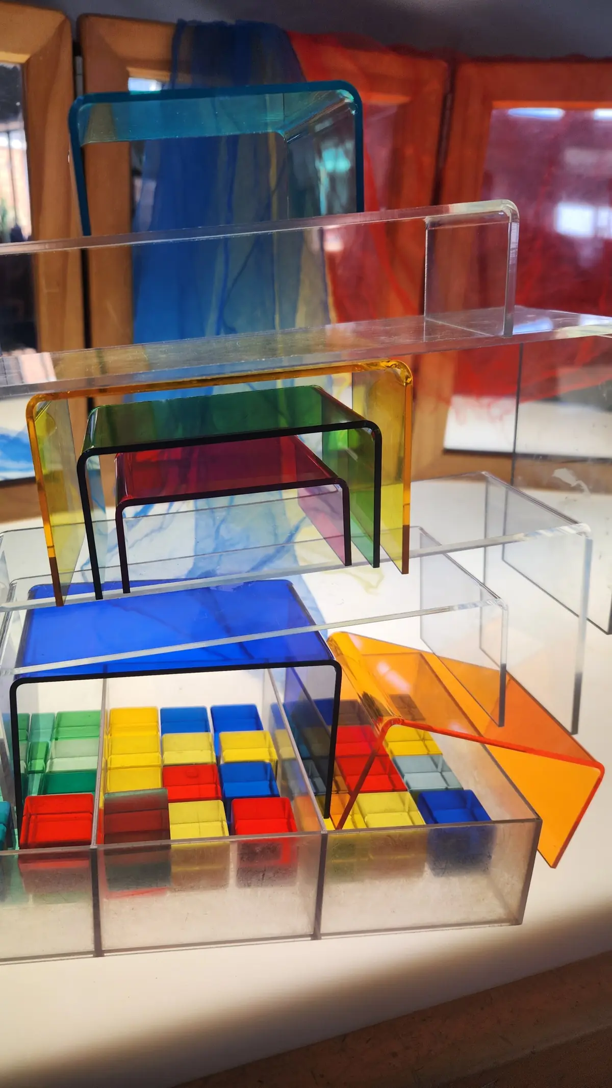 Coloured acrylic blocks stacked on a light table.